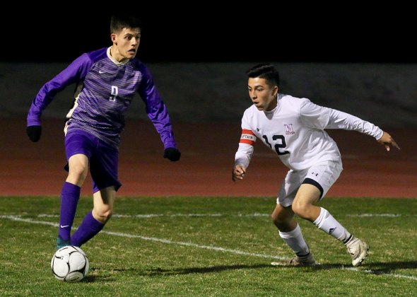Lemoore's Armando Salinas and Nipomo's Carlos Diaz battle for the ball in Wednesday's Div. 2 playoff game which the Tigers won 4-0. Lemoore will host McLane High Friday night in Tiger Stadium.